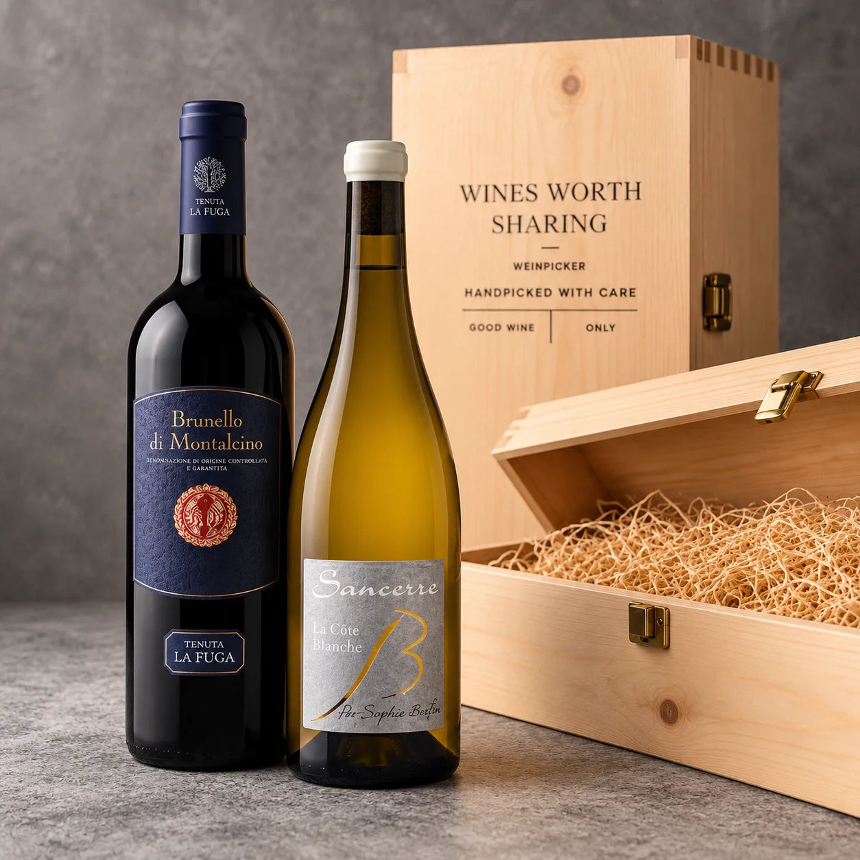 Two premium wine bottles, Brunello di Montalcino La Fuga and Sancerre La Côte Blanche, displayed with a wooden Weinpicker gift box against elegant grey velvet.