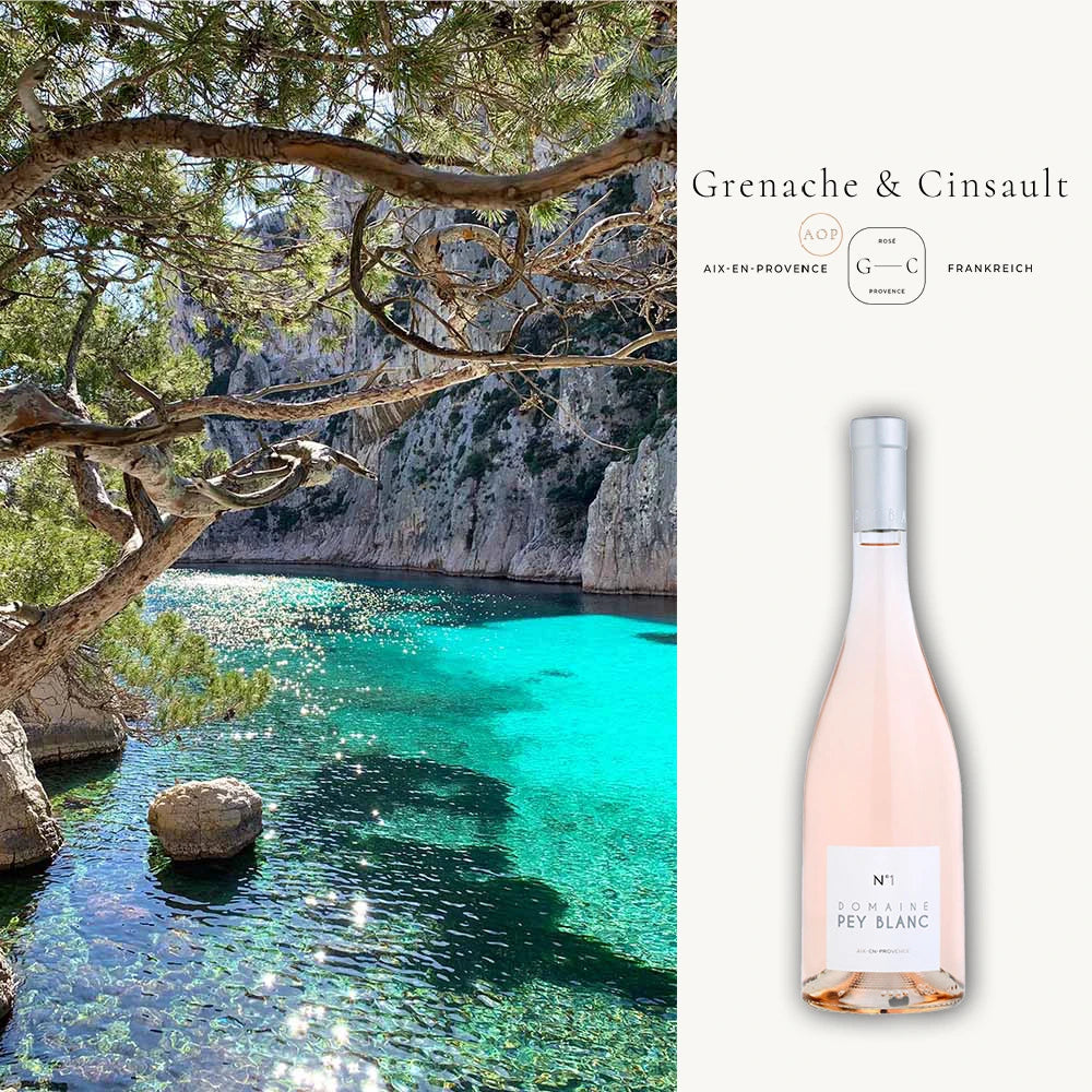 Roséwein Provence: Kristallklare türkise Bucht, Felsenkulisse, blassrosa Provence-Rosewein Flasche rechts.